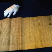 A member of staff at The National Archives of Scotland, in Edinburgh, looks over the Act of Union of the Scottish Parliament