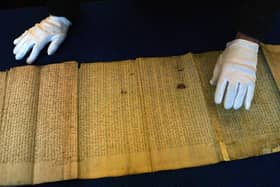 A member of staff at The National Archives of Scotland, in Edinburgh, looks over the Act of Union of the Scottish Parliament