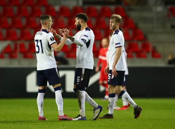 Borna Barisic, Connor Goldson and Filip Helander of Rangers celebrate following the UEFA Europa League Round of 32 match between Royal Antwerp FC and Rangers FC at Bosuilstadion on February 18, 2021 (Photo by Dean Mouhtaropoulos/Getty Images)