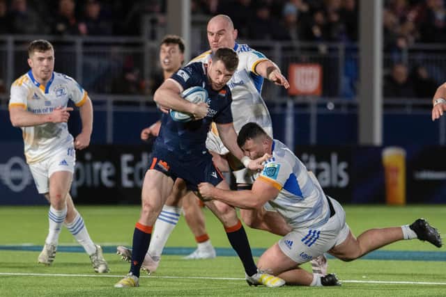 Edinburgh's Mark Bennett and Leinster's Michael Milne during the URC clash at the DAM Health Stadium.