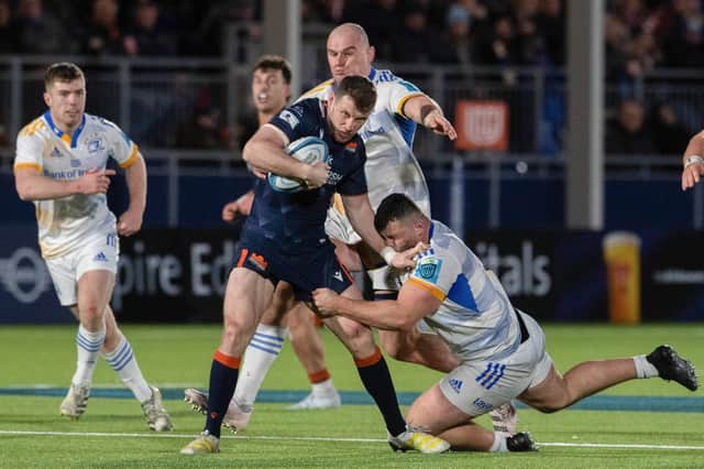 Edinburgh's Mark Bennett and Leinster's Michael Milne during the URC clash at the DAM Health Stadium.