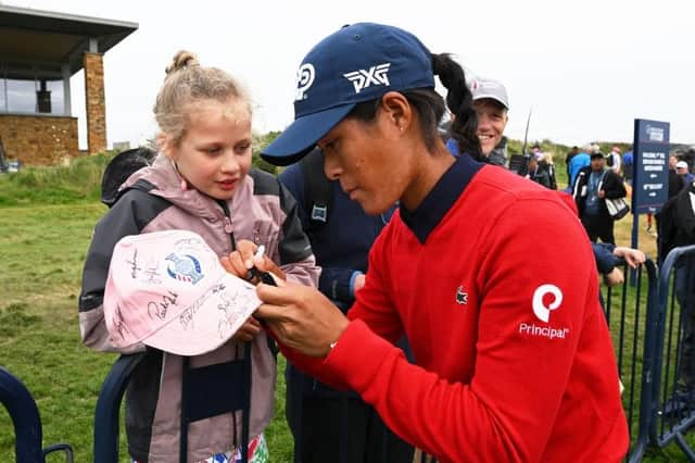 Celine Boutier signs a hat for a young fan after opening up a three-shot lead following the third round of the Freed Group Women's Scottish Open presented by Trust Golf at Dundonald Links. Picture: Octavio Passos/Getty Images.