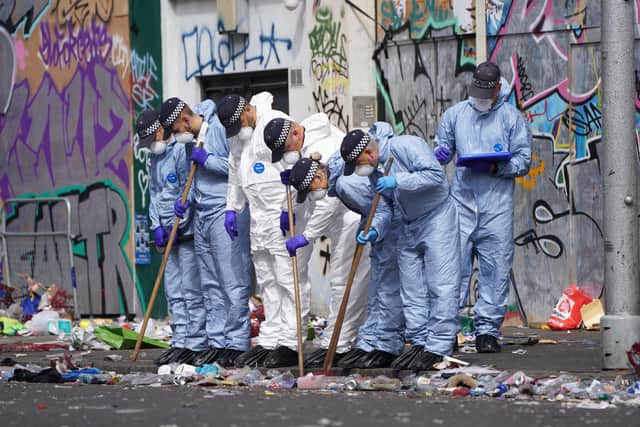 Forensics officers comb the scene in Ladbroke Grove, west London, where 21-year-old Takayo Nembhard, a rapper from Bristol, has died after being stabbed on the final day of the Notting Hill Carnival. Picture: Kirsty O'Connor/PA Wire