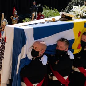 The Duke of Edinburgh's coffin, covered with his Personal Standard, being carried into St George's Chapel, Windsor Castle, Berkshire.