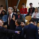 Police and security staff deal with a protester in the public gallery during First Minister's Questions at Scottish Parliament (Picture: Jeff J Mitchell/Getty Images)