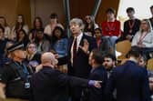 Police and security staff deal with a protester in the public gallery during First Minister's Questions at Scottish Parliament (Picture: Jeff J Mitchell/Getty Images)