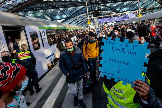 Volunteers wait to help refugees from Ukraine arriving at the main train station in Berlin, Germany (Picture: Hannibal Hanschke/Getty Images)