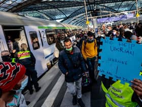 Volunteers wait to help refugees from Ukraine arriving at the main train station in Berlin, Germany (Picture: Hannibal Hanschke/Getty Images)