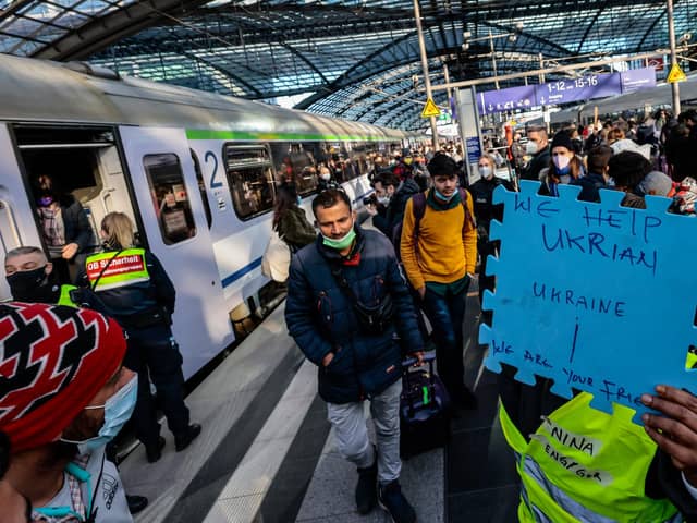 Volunteers wait to help refugees from Ukraine arriving at the main train station in Berlin, Germany (Picture: Hannibal Hanschke/Getty Images)