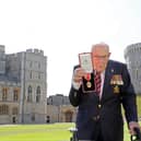 Second World War veteran Captain Sir Tom Moore poses with his medal after being made a Knight Bachelor for raising over £32 million for the NHS during the Covid pandemic (Picture: Chris Jackson/pool/AFP via Getty Images)