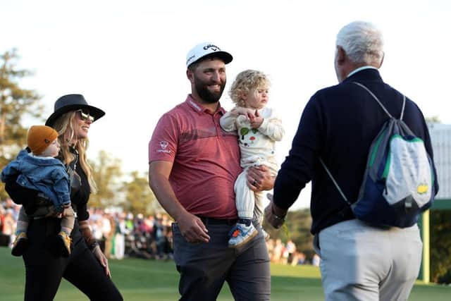 Jon Rahm celebrates with his wife and their two young sons and also his dad, Edorta, on the 18th green. Picture: Patrick Smith/Getty Images.