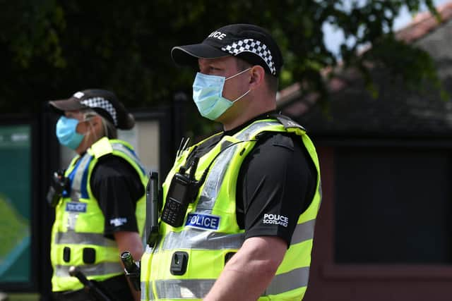 Police Scotland officers wearing PPE. Picture: John Devlin