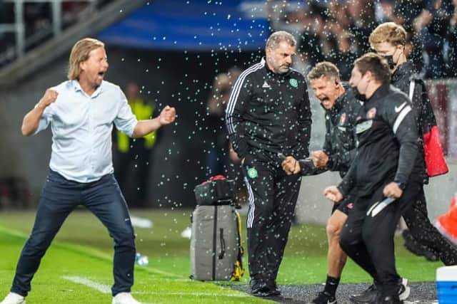 Celtic manager Ange Postecoglou (centre) looks dejected at full time as FC Midtjylland manager Bo Henriksen celebrates. (Photo by Claus Fisker / SNS Group)