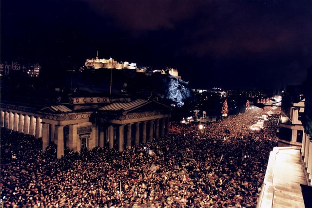 Revellers celebrating New Year on Princes street at The Mound with Edinburgh Castle in the background. There were a reported 400,000 people in attendance.