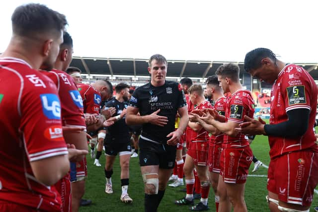 Stafford McDowall and the Glasgow Warriors players receive the applause of the Scarlets after their win on Saturday. (Photo by Michael Steele/Getty Images)