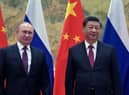Russian President Vladimir Putin (L) and Chinese President Xi Jinping pose during their meeting in Beijing, on February 4, 2022. (Photo by Alexei Druzhinin / Sputnik / AFP) (Photo by ALEXEI DRUZHININ/Sputnik/AFP via Getty Images)
