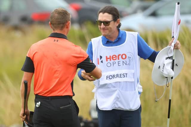 Grant Forrest is congratulated by his caddie John McClure after they joined forces to pull off a dramatic victory in the Hero Open on Sunday. Picture: Andrew Redington/Getty Images.