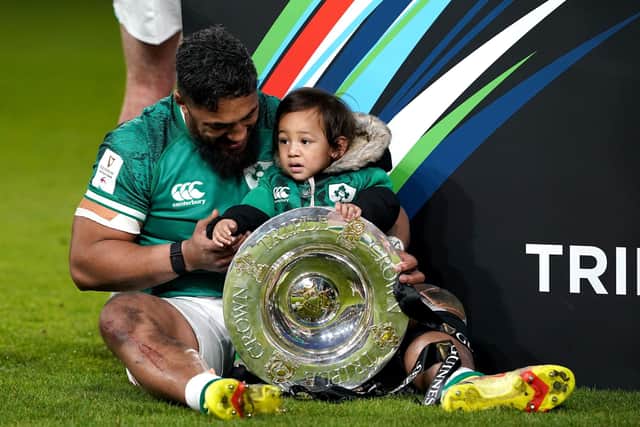 Bundee Aki celebrates Ireland's Triple Crown success with his son Andronicus Junior Papamau Aki. Picture: Brian Lawless/PA Wire