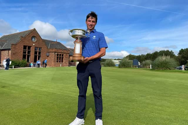 Gullane's Oliver Mukherjee shows off the trophy after winning the Scottish Amateur at Gailes Links. Picture: Scottish Golf.