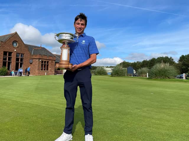 Gullane's Oliver Mukherjee shows off the trophy after winning the Scottish Amateur at Gailes Links. Picture: Scottish Golf.