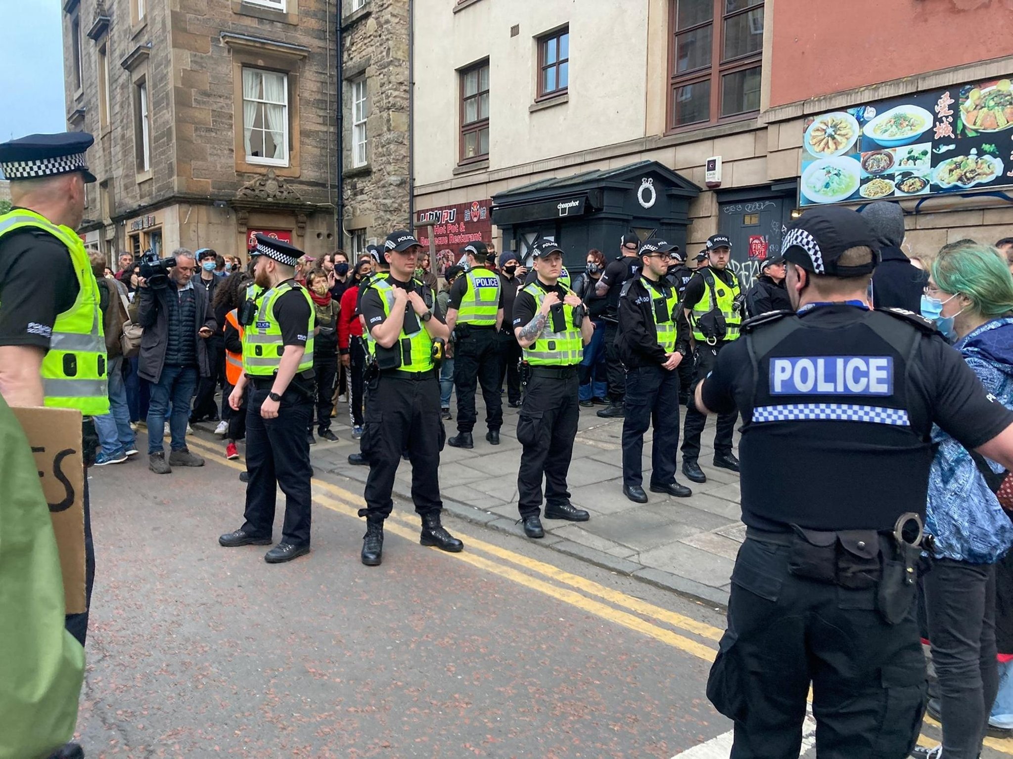 Crowds cheer and cry as immigration officers leave Edinburgh property following raid and arrests