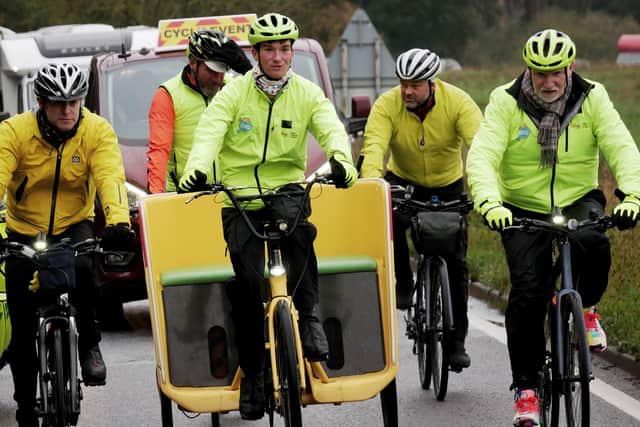 Sir Tom Hunter rides alongside presenter Matt Baker and rickshaw rider, Josh/Emma during the BBC Children in Need Rickshaw Challenge in 2019.