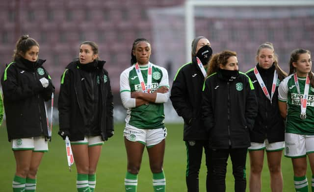 Hibs players look dejected as they receive their runners-up medals after losing 2-0 to Rangers in the SWPL Sky Sports Cup final at Tynecastle Park. (Photo by Mark Scates / SNS Group)