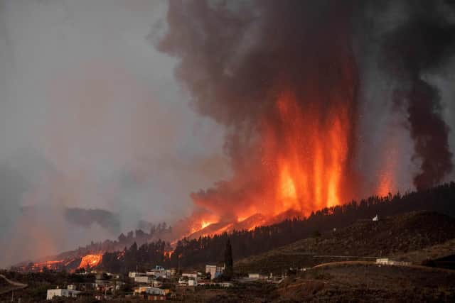 Mount Cumbre Vieja erupts in El Paso, spewing out columns of smoke, ash and lava as seen from Los Llanos de Aridane on the Canary island of La Palma on September 19, 2021. (Image credit: Desiree Martin/AFP via Getty Images)