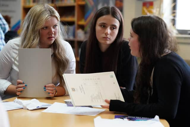 Pupils l-r Tess Worley, Abbie Hart and 
Leah Mathieson from Craigmount High School in Edinburgh look at their exam results during SQA Results Day 2023. About 140,000 pupils across Scotland are receiving exam results for their Nationals, Highers, Advanced Highers and national certificates. Picture date: Tuesday August 8, 2023. PA Photo. See PA story SCOTLAND Exams. Photo credit should read: Andrew Milligan/PA Wire