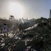 People search through buildings, destroyed during Israeli air raids in the southern Gaza Strip. Heavy fighting rages in the northern Gaza Strip as Israel encircles the area, despite increasingly pressing calls for a humanitarian truce.