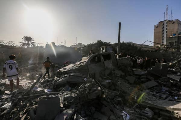 People search through buildings, destroyed during Israeli air raids in the southern Gaza Strip. Heavy fighting rages in the northern Gaza Strip as Israel encircles the area, despite increasingly pressing calls for a humanitarian truce.