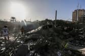 People search through buildings, destroyed during Israeli air raids in the southern Gaza Strip. Heavy fighting rages in the northern Gaza Strip as Israel encircles the area, despite increasingly pressing calls for a humanitarian truce.