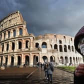 A man wearing a protective mask passes by the Coliseum in Rome (Photo: Alberto PIZZOLI / AFP) (Photo by ALBERTO PIZZOLI/AFP via Getty Images)