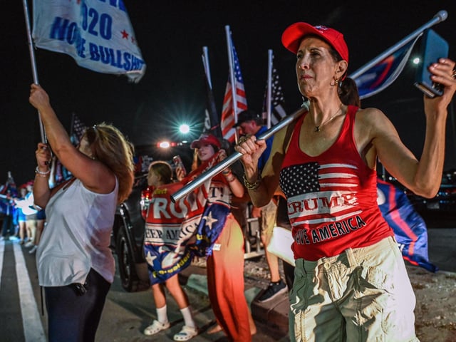Supporters of former US President Donald Trump stand outside his residence in Mar-A-Lago, Palm Beach, Florida on August 8, 2022. - A senior White House official has told CBS the West Wing was given no notice of the FBI raid on Mr Trump's home.