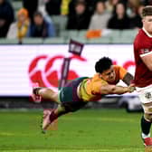 Huw Jones (R) runs away from Australia's Len Ikitau during the British and Irish Lions victory at Melbourne Cricket Ground. (Photo by WILLIAM WEST/AFP via Getty Images)