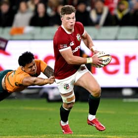 Huw Jones (R) runs away from Australia's Len Ikitau during the British and Irish Lions victory at Melbourne Cricket Ground. (Photo by WILLIAM WEST/AFP via Getty Images)