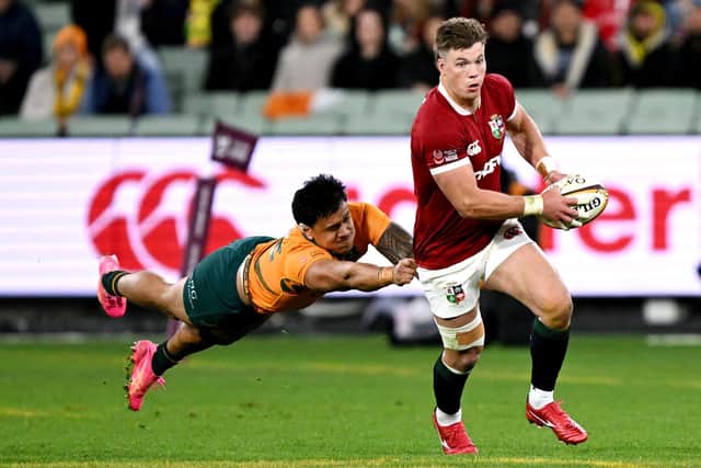 Huw Jones (R) runs away from Australia's Len Ikitau during the British and Irish Lions victory at Melbourne Cricket Ground. (Photo by WILLIAM WEST/AFP via Getty Images)