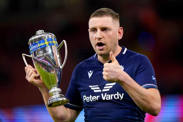 Scotland's Finn Russell celebrates with the Doddie Weir Cup at the end of the Guinness Six Nations match at the Principality Stadium, Cardiff. Picture date: Saturday February 3, 2024.