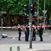 Police stand near a body in a cordoned-off area where a car ploughed into a crowd near Tauentzienstrasse in central Berlin, on June 8, 2022.  A police spokeswoman said the driver was detained at the scene after the car ploughed into a shop front along busy shopping street Tauentzienstrasse. It was not clear whether the crash was intentional. (Photo by John MACDOUGALL / AFP) (Photo by JOHN MACDOUGALL/AFP via Getty Images)