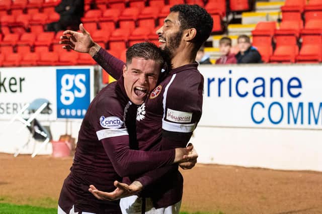 Josh Ginnelly is congratulated by Cammy Devlin after scoring for Hearts.