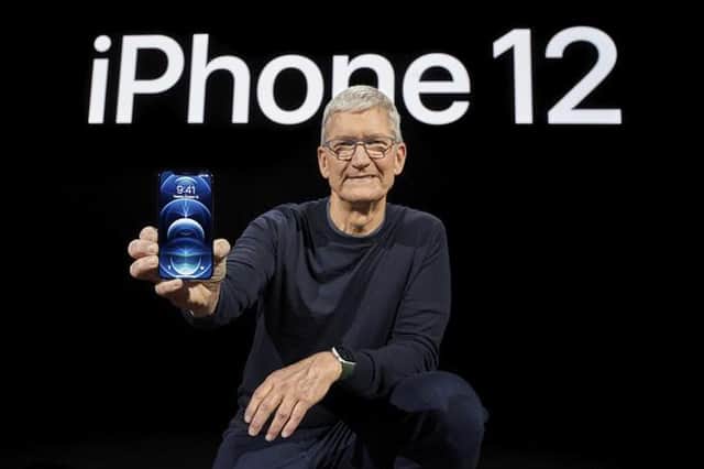 Apple CEO Tim Cook shows off the new iPhone 12.