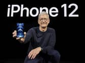 Apple CEO Tim Cook shows off the new iPhone 12.