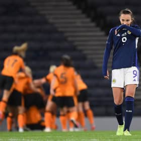 Scotland's Caroline Weir looks dejected while Republic of Ireland celebrate making it 1-0 at Hampden.