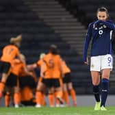 Scotland's Caroline Weir looks dejected while Republic of Ireland celebrate making it 1-0 at Hampden.