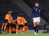 Scotland's Caroline Weir looks dejected while Republic of Ireland celebrate making it 1-0 at Hampden.