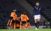Scotland's Caroline Weir looks dejected while Republic of Ireland celebrate making it 1-0 at Hampden.