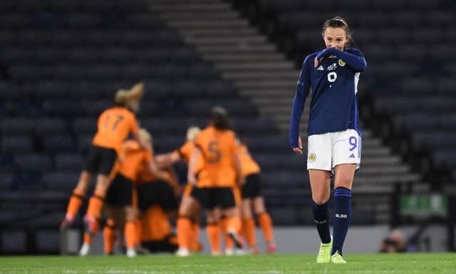 Scotland's Caroline Weir looks dejected while Republic of Ireland celebrate making it 1-0 at Hampden.
