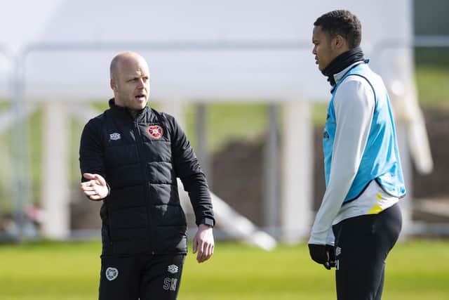 Hearts interim manager Steven Naismith gives defender Toby Sibbick some advice during training.