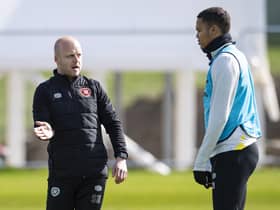 Hearts interim manager Steven Naismith gives defender Toby Sibbick some advice during training.