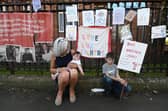 Maureen Cannell with her grandchildren outside Whiteinch Library in Glasgow. Picture: John Devlin